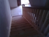 down view of stairs with mahogany handrail and tulipwood steps with bottom step in mahogany